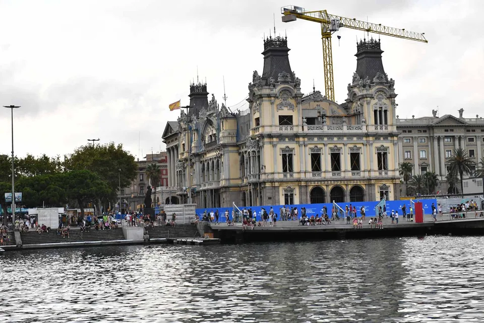 Historic waterfront building at Barcelona’s Port Vell, viewed from the water